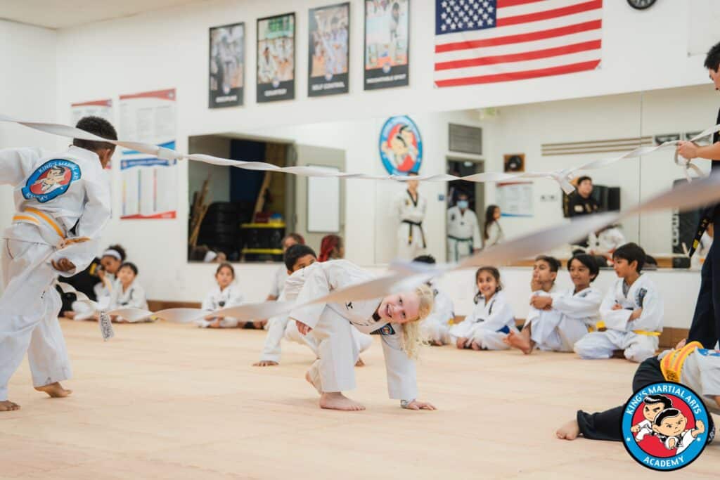 King's Martial Arts Academy young students smiling during Taekwondo class.
