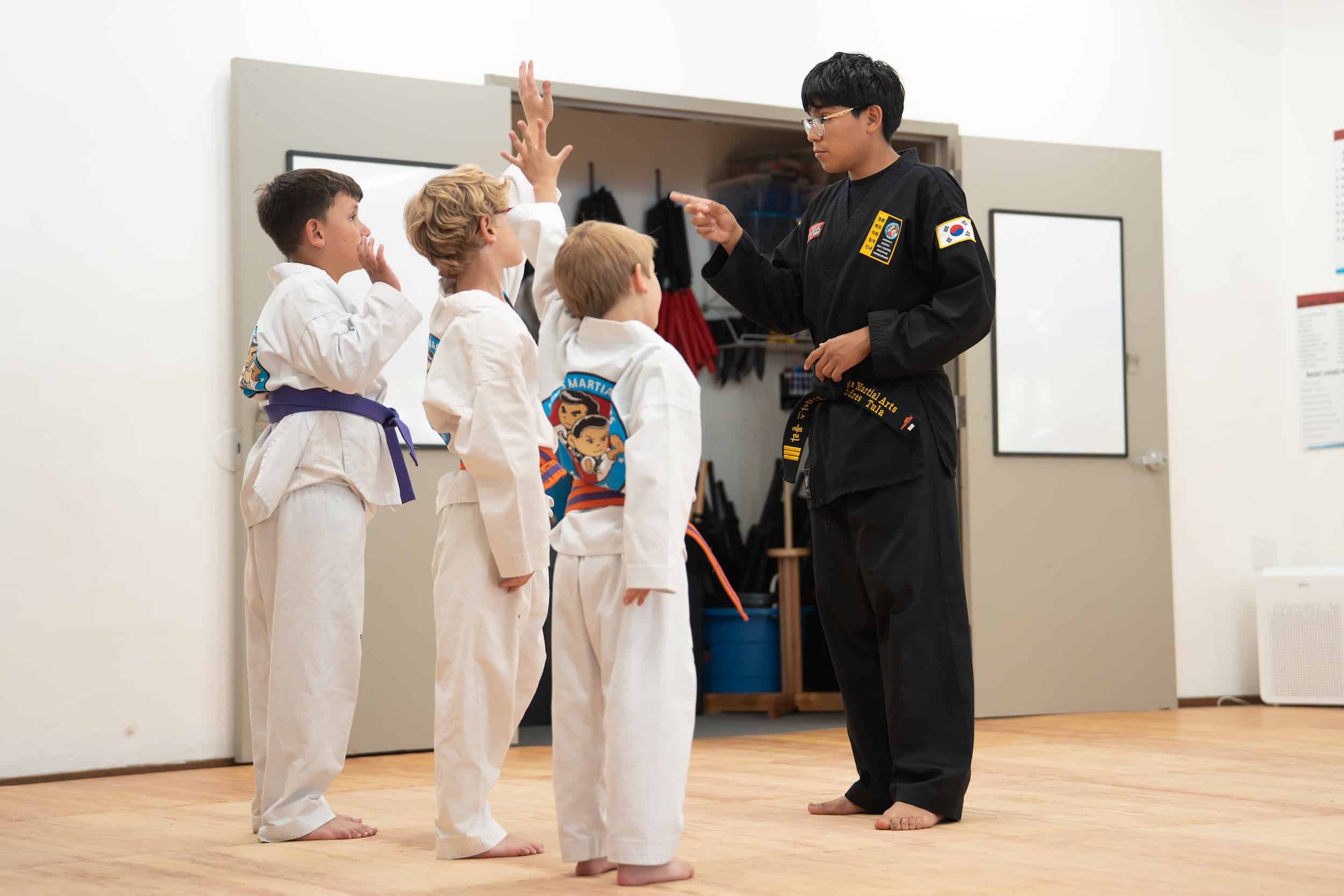 King's Martial Arts instructor teaching young Taekwondo students.