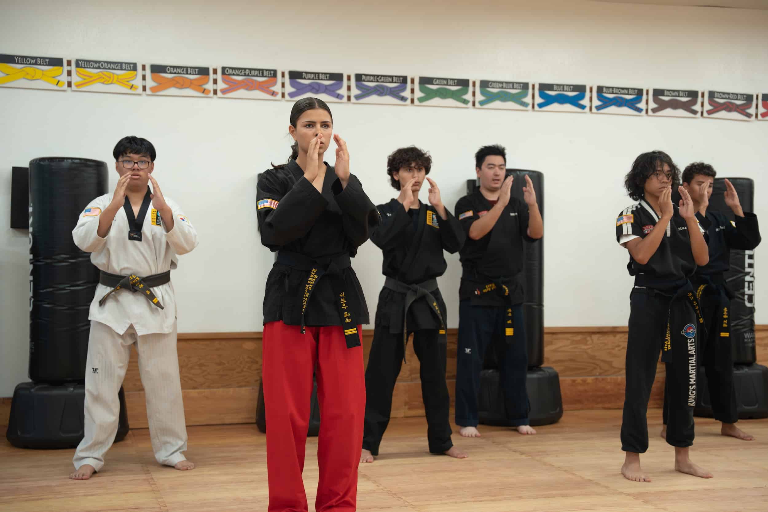 King's Martial Arts Academy black belt students practicing proper Taekwondo techniques.